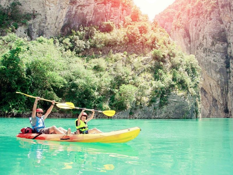 Man and child sitting in a canoe and enjoying the beautiful scenery